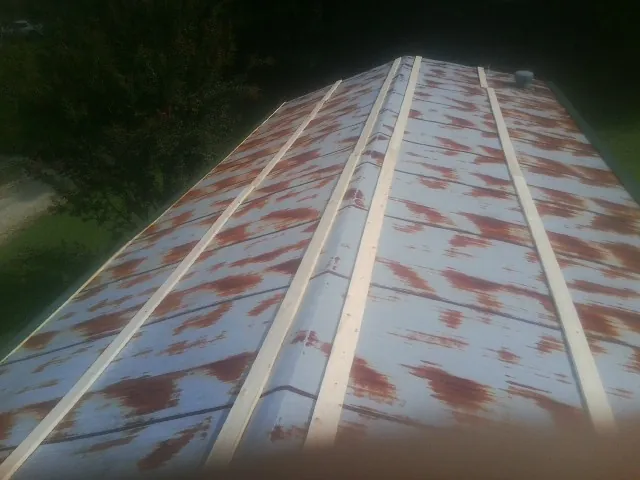 Rusted metal roof panels with new wood purlins before replacement — Storm Damage Roof Repair in Anna by Roofing Brothers